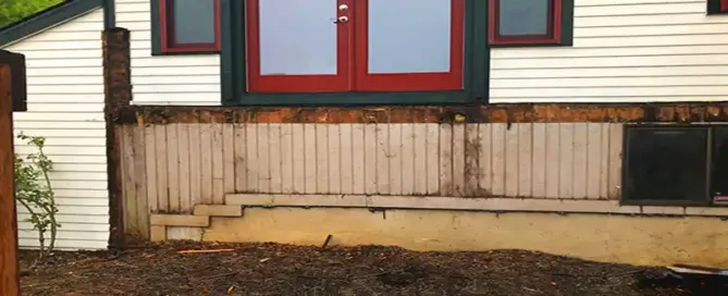 siding behind a deck that has rotted due to construction defects